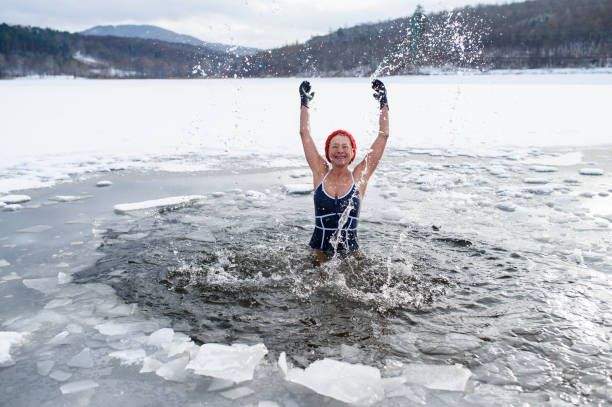woman bursting from icy water